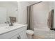 Well-lit bathroom with a white vanity, white tub, shower combo, and a neutral color scheme at 1113 Idyllic Ln, Waxhaw, NC 28173