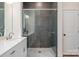 Modern bathroom featuring frameless shower enclosure with a marble tile surround and a double vanity at 1113 Idyllic Ln, Waxhaw, NC 28173