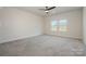 Large bonus room featuring neutral paint, plush carpet, and ceiling fan, illuminated by natural light at 1113 Idyllic Ln, Waxhaw, NC 28173
