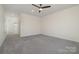 Large bonus room featuring neutral paint, plush carpet, and ceiling fan, illuminated by natural light at 1113 Idyllic Ln, Waxhaw, NC 28173