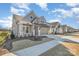 Charming home with attractive siding, landscaping, inviting entrance, and attached two car garage at 1113 Idyllic Ln, Waxhaw, NC 28173