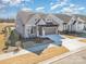 New construction featuring gray siding, stone accents, a two-car garage, and beautifully landscaped front yard at 1113 Idyllic Ln, Waxhaw, NC 28173