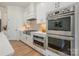 Modern kitchen design with built-in oven and microwave, sleek cabinetry, and tiled backsplash at 1113 Idyllic Ln, Waxhaw, NC 28173