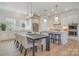 Open kitchen and dining area with a center island, stainless steel appliances, and a long dining table at 1113 Idyllic Ln, Waxhaw, NC 28173