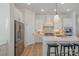 Bright kitchen with a center island, stainless steel appliances, and white cabinetry at 1113 Idyllic Ln, Waxhaw, NC 28173
