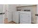 Well-lit laundry room with white washer and dryer and overhead cabinets for storage at 1113 Idyllic Ln, Waxhaw, NC 28173