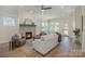Open living room featuring a stone fireplace, wood-look floors, and large windows for natural light at 1113 Idyllic Ln, Waxhaw, NC 28173