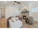 Beautiful living room featuring a stone fireplace, a ceiling fan, and large windows for natural light at 1113 Idyllic Ln, Waxhaw, NC 28173