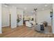 Open living space with wood-look floors that leads into a dining area and kitchen at 1113 Idyllic Ln, Waxhaw, NC 28173