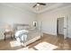 Bright main bedroom with tray ceiling, ensuite bathroom, and a spacious layout with hardwood floors at 1113 Idyllic Ln, Waxhaw, NC 28173
