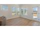 Bright sunroom features many windows and door with an outdoor view and hardwood floors at 1113 Idyllic Ln, Waxhaw, NC 28173