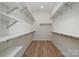 Spacious walk-in closet with custom shelving and racks provides ample storage space at 1113 Idyllic Ln, Waxhaw, NC 28173