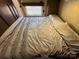 Comfortable bed in the camper with overhead lighting and cabinets for storage at 113 Cedar Ln, New London, NC 28127