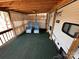 Cozy deck with a wooden roof, carpet and 2 chairs at 113 Cedar Ln, New London, NC 28127
