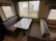 Cozy dining area featuring a table with booth seating and natural light from the window at 113 Cedar Ln, New London, NC 28127