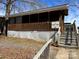 Charming single-story home with screened porch, wooden accents, and inviting entrance at 113 Cedar Ln, New London, NC 28127