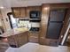 Compact kitchen with wood cabinets, modern appliances, and ample counter space at 113 Cedar Ln, New London, NC 28127