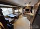 Camper interior with a dinette, sofa, kitchen, and entertainment center at 113 Cedar Ln, New London, NC 28127