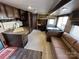 Spacious camper interior with a kitchen, dinette, sofa, and bunk beds at 113 Cedar Ln, New London, NC 28127