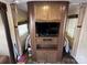 Entertainment center in camper featuring a flat-screen TV and storage cabinets at 113 Cedar Ln, New London, NC 28127