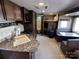 Spacious camper interior with a kitchen, dinette, and bunk beds at 113 Cedar Ln, New London, NC 28127