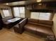 Bright living room featuring a cozy couch and a dining table with ample seating at 113 Cedar Ln, New London, NC 28127