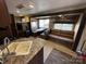 Inviting living room features a comfortable leather couch and a cozy dining area at 113 Cedar Ln, New London, NC 28127