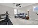Bright bonus room with ceiling fan, comfortable seating, and exercise equipment at 117 Stowe Rd, Belmont, NC 28012