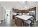 Stylish kitchen featuring stainless steel appliances, brown cabinets, and a large white countertop island with seating at 117 Stowe Rd, Belmont, NC 28012