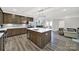 Open kitchen with stainless steel appliances, island, and quartz countertops at 117 Stowe Rd, Belmont, NC 28012