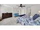 This carpeted main bedroom features a ceiling fan, blue sofa and is brightly lit with natural light at 117 Stowe Rd, Belmont, NC 28012