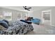 Bright main bedroom features a ceiling fan and a view into the ensuite bathroom at 117 Stowe Rd, Belmont, NC 28012