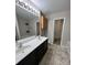 Bright bathroom featuring a double sink vanity, neutral paint, and a linen closet at 14331 Evening Flight Ln, Charlotte, NC 28262
