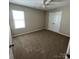 Cozy bedroom with carpet flooring, a ceiling fan and a double door closet at 14331 Evening Flight Ln, Charlotte, NC 28262