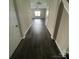 Inviting hallway with dark wood-look floors leading to a bright, open living space at 14331 Evening Flight Ln, Charlotte, NC 28262