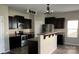 Modern kitchen with dark cabinets, stainless steel appliances, and a breakfast bar at 14331 Evening Flight Ln, Charlotte, NC 28262