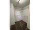 Spacious walk-in closet with white shelving and neutral carpet at 14331 Evening Flight Ln, Charlotte, NC 28262