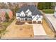 Stunning overhead view of a stucco home with a dark roof, spacious lawn, and charming curb appeal at 15818 Sparrowridge Ct, Charlotte, NC 28278