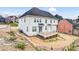 Exterior view of white two-story home featuring a deck and landscaped backyard on a sunny day at 15818 Sparrowridge Ct, Charlotte, NC 28278