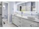 Stylish bathroom features a vanity with dual vessel sinks, illuminated mirror, and modern fixtures at 15818 Sparrowridge Ct, Charlotte, NC 28278
