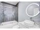 Well lit bathroom featuring light grey tiles, a modern sink and a lighted mirror at 15818 Sparrowridge Ct, Charlotte, NC 28278