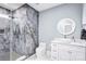 Bathroom featuring a glass enclosed shower, unique stone tiling and single sink vanity at 15818 Sparrowridge Ct, Charlotte, NC 28278