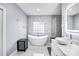 Modern bathroom featuring a soaking tub, sleek marble tile, and a glass shower, creating a spa-like retreat at 15818 Sparrowridge Ct, Charlotte, NC 28278