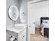 Well lit bathroom featuring light grey walls, a modern sink and a lighted mirror at 15818 Sparrowridge Ct, Charlotte, NC 28278