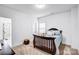 Cozy bedroom featuring plush carpet, neutral walls and a dark wood crib and bed at 15818 Sparrowridge Ct, Charlotte, NC 28278