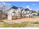 Beautiful stucco home with a dark roof, complemented by stone accents and professional landscaping at 15818 Sparrowridge Ct, Charlotte, NC 28278
