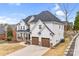 Attractive stucco house featuring a dark roof, an attached two-car garage, and well-maintained landscaping at 15818 Sparrowridge Ct, Charlotte, NC 28278