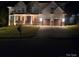 Stunning home exterior featuring a manicured lawn, covered porch, and a two-car garage at 15818 Sparrowridge Ct, Charlotte, NC 28278