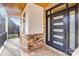 Inviting front porch showcasing stone accents, a modern front door, and a stained wood ceiling at 15818 Sparrowridge Ct, Charlotte, NC 28278