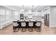 Modern kitchen with a large island, stainless steel appliances, white cabinets, and stylish pendant lighting at 15818 Sparrowridge Ct, Charlotte, NC 28278